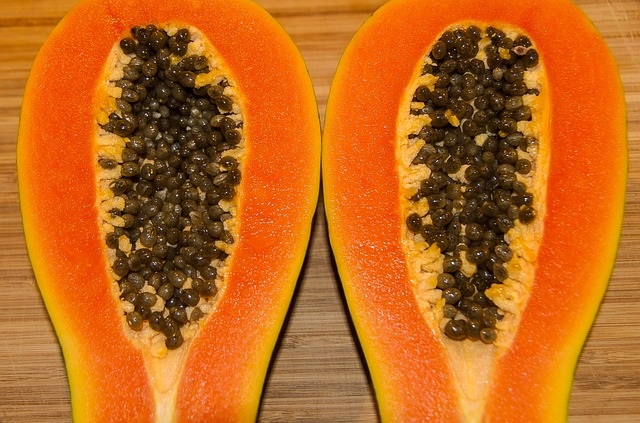 2 real sliced papayas showing seeds
